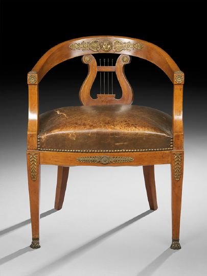 Empire Mahogany Tub Chair: Empire Mahogany Tub Chair, early 19th century, the low domed crest with applied ormolu mask and patera accents above a lyre-form splat, joined by downswept arms to the padded seat, raised on tapering