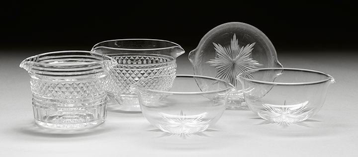 Five English Regency Cut-Glass Wine Rinsers: Collection of English Regency Cut-Glass Wine Rinsers, second quarter 19th century, comprised of three matching bowl-form rinsers, simply decorated with bold star-form cut bases, h. 2-1/2", dia. 5", a 
