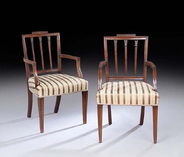 Pair of George III-Style Mahogany Armchairs: Pair of George III-Style Mahogany Armchairs, early 20th century, in the Sheraton taste, each with a carved crest above a rectangular back fitted with three lotus-carved splats, joined by flat arms to 