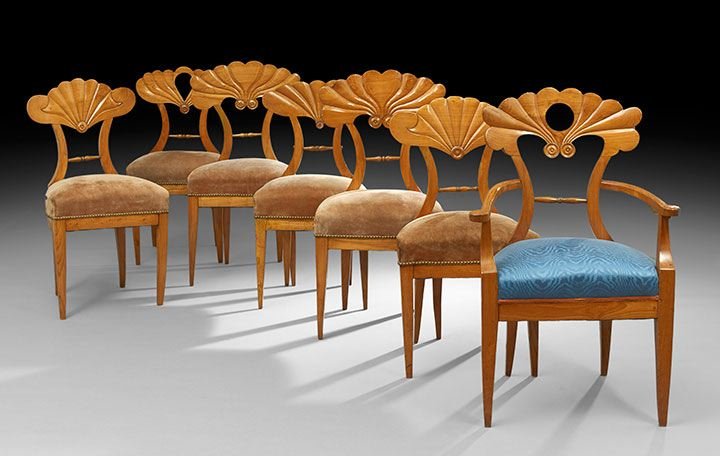 Suite of Seven Biedermeier Dining Chairs: Mixed Suite of Seven Biedermeier Elm and Fruitwood Dining Chairs, second quarter 19th century, consisting of one armchair and six sidechairs, all with a ribbed fan-form crest above the padded seat, ra