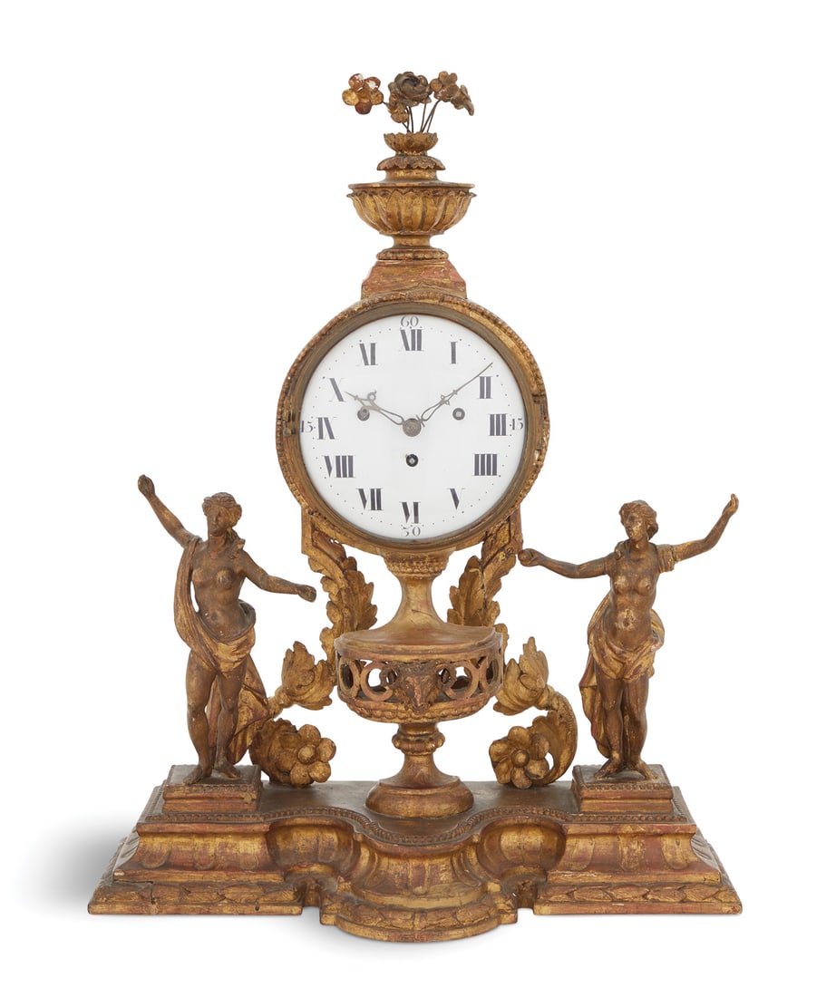 Carved Giltwood Grand Sonnerie Mantel Clock: Rare Austrian Carved Giltwood Grand Sonnerie Mantel Clockca. 1800, with a lotus-carved giltwood urn finial set with wire-mounted giltwood flowers, the dial trimmed with carved beading, supported by a