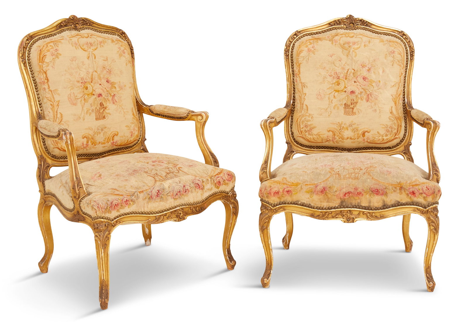 Louis XV-Style Giltwood Fauteuils: Louis XV-Style Giltwood Fauteuilslate 19th century, each with a shaped and padded back surmounted by a foliate shell crest, joined by scrolling and padded arms to the like seat, raised on molded cabri