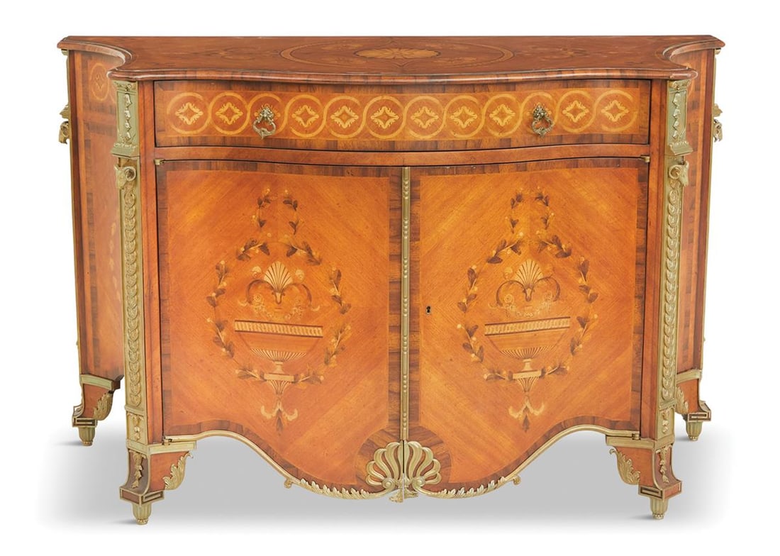 Continental Mixed Woods Cabinet: Continental Mixed Woods Cabinet the shaped and bowed top with a banded and molded edge and a patera- and guilloche-inlaid design, above a conforming case fitted with a single long drawer over two cabi