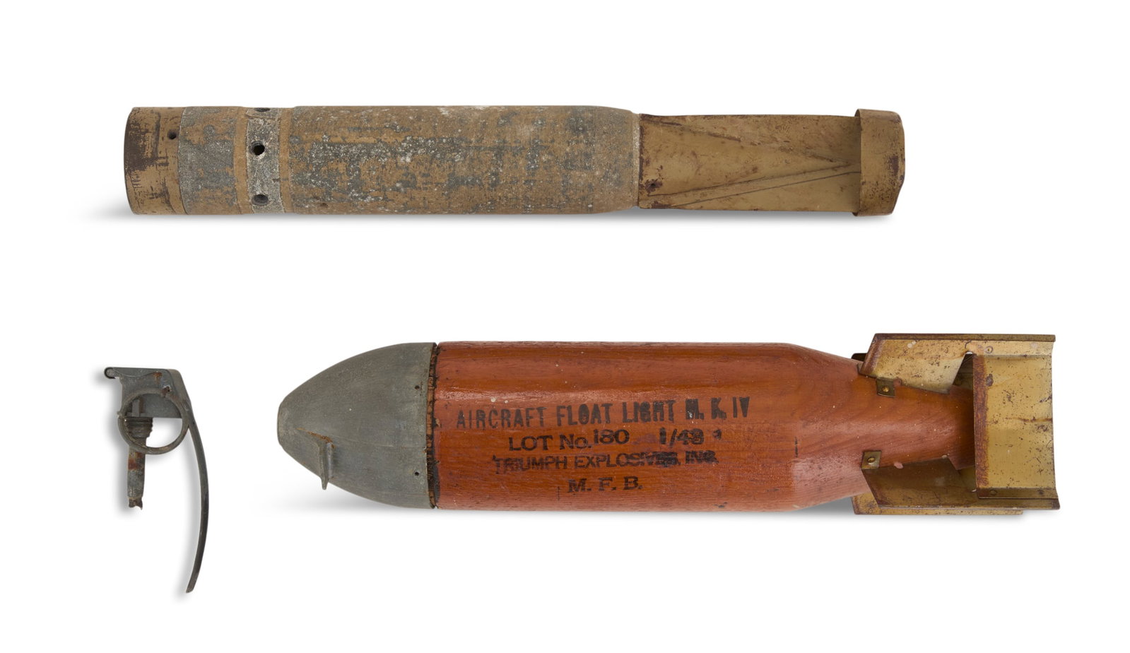 Three Combat Relics: Three Combat Relics including: a downed pilot marker stamped "Aircraft Float Light M.K. IV / Lot No. 180 1/43 / Triumph Explosive Inc. / M.F.B.", with wood body, pot metal cap and brass four