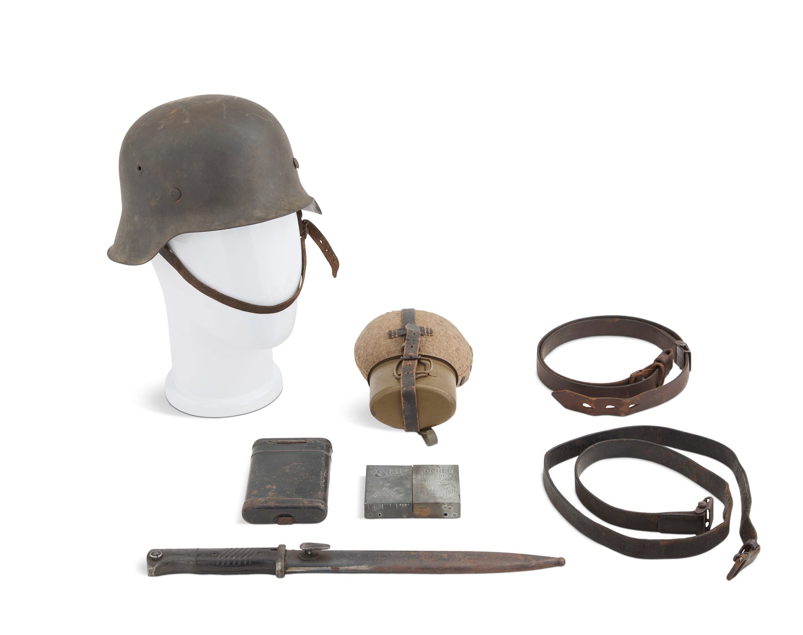 WWII German Helmet and Gear: WWII German Helmet and Gear including: an M-42 helmet, size 64, with liner and chin strap, printed owner's name "Ogfr. Gohring"; an Esbit Kocher stove with fuel; a K-98 cleaining kit AR44; a