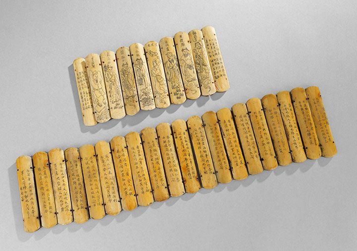 Chinese Book: Chinese Book, 20th century, the bone slats engraved with scenes of immortals and text, joined together with thread,