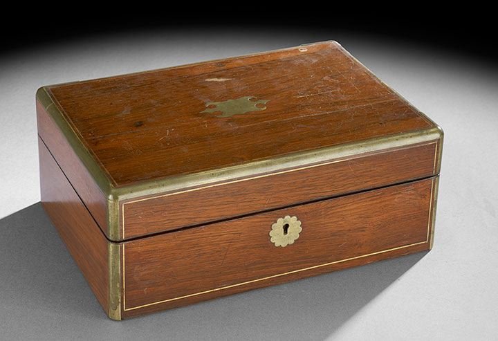 English Victorian Rosewood and Brass Workbox: English Victorian Rosewood and Brass Workbox, mid-19th century, the case exterior with brass edges and brass line inlay on the top and front and the front fitted with a scalloped brass escutcheon, the