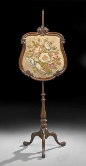 Victorian Mahogany and Rosewood Pole Screen: Victorian Mahogany, Rosewood and Faux Rosewood Pole Screen, third quarter 19th century, the shaped frame mounted with antique floral needlepoint, on a tripodal base ending in pad feet, h. 56", w. 19",