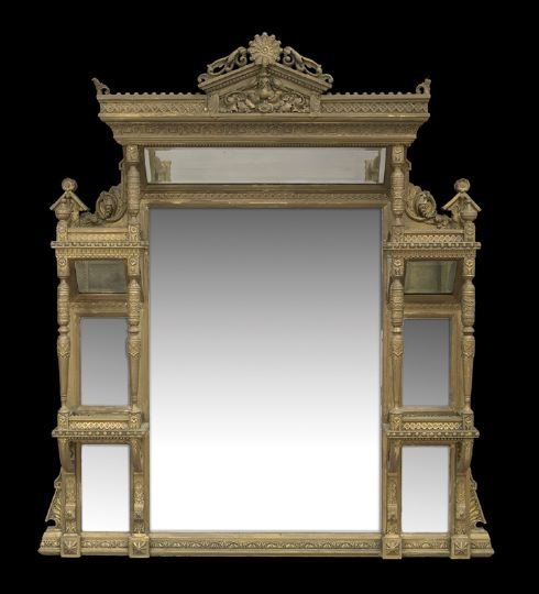American Aesthetic Movement Giltwood Mantle Mirror: American Aesthetic Movement Giltwood Mantle Mirror, fourth quarter 19th century, the projecting cornice with a carved crest over an angled mirror plate oriented to reflect back into the room, the larg
