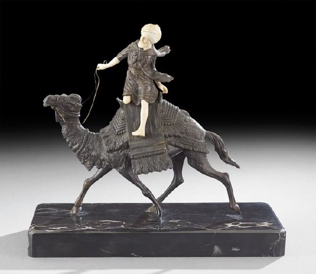 Orientalist Figure in the Viennese Style: Orientalist Figure in the Viennese Style, the Arabian figure with an ivory-colored head and limbs, depicted riding a camel with a traditional Middle Easter saddle, resting on a black marble plinth, h.