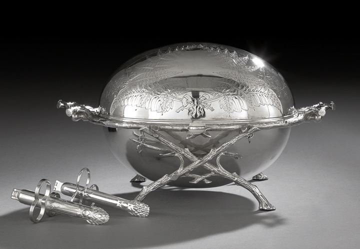 Victorian Silverplate Revolving Vegetable Dish and: Victorian Silverplate Revolving Vegetable Dish and Two Later Asparagus Tongs, the dish dated by design registry November 4, 1870, of oval form, with a naturalistic currule "branch" frame, the domed li