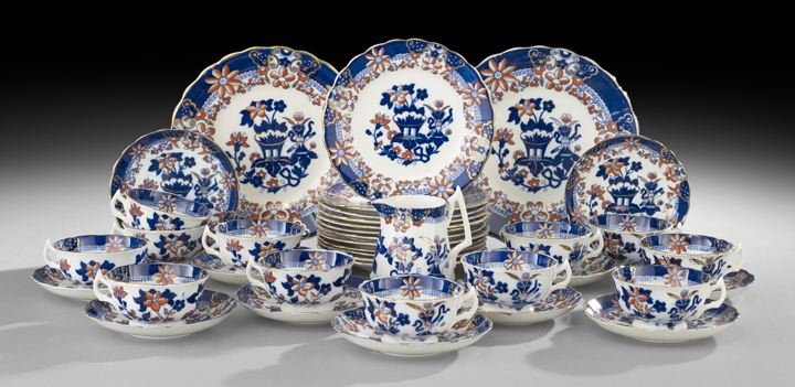 Victorian Flow Blue "Imari" Partial Tea Set: Victorian Flow Blue Partial Tea Set in the Imari Palette, fourth quarter 19th century, cobalt borders trimmed in gilt and punctuated with orange flowers decorate the set, the central panels depicting