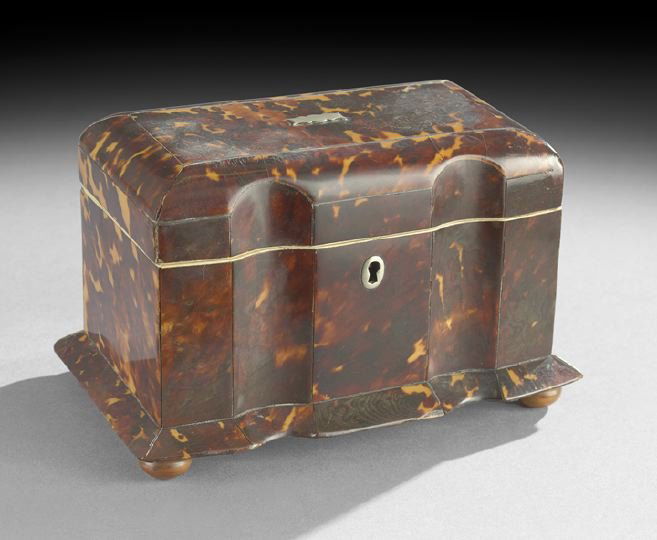 English Regency Tortoiseshell Tea Caddy: English Regency Tortoiseshell Tea Caddy, first quarter 19th century, of block front design, sitting on maple bun feet with a conforming base molding, the front lock set with a silver escutcheon, the i