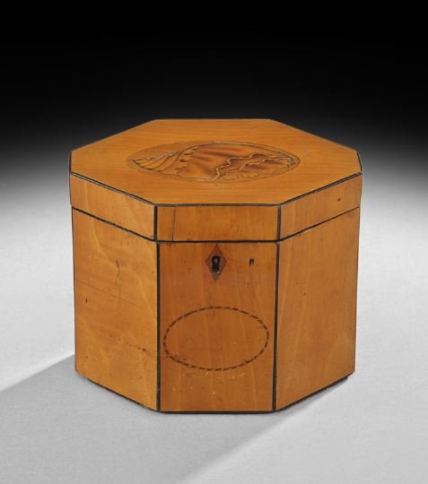 George III Inlaid Satinwood Tea Caddy: George III Inlaid Satinwood Tea Caddy, ca. 1800, English, the octagonal caddy outlined in ebony stringing with a barber pole inlaid oval on the facade under the keyhole escutcheon, the top beautifully