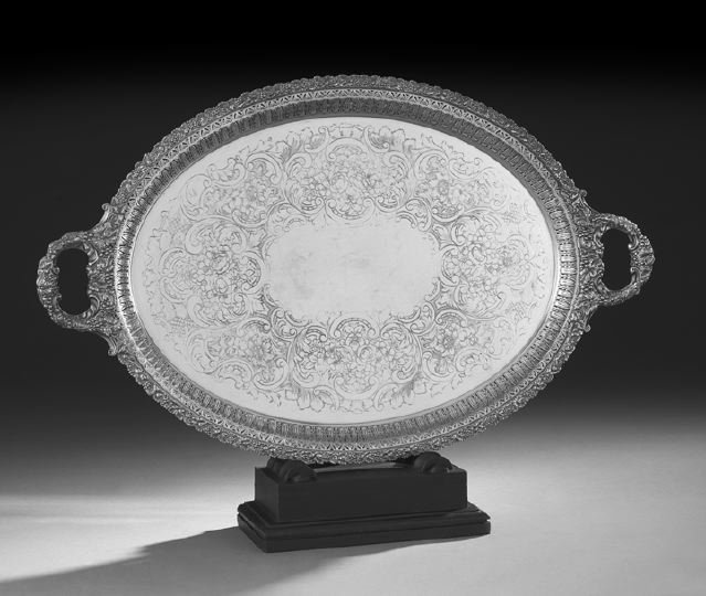 Edwardian Silverplate Tray: Edwardian Silverplate Tray, first quarter 20th century, of oval form, with pierced rim and applied "vintage" rim, with opposing handles en suite, the plateau flat-embossed with a wide floral rococo ba