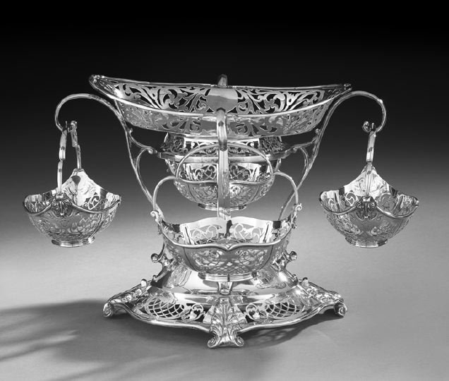George V Sterling Silver Epergne: George V Sterling Silver Epergne, hallmarked Sheffield, 1912-1913, by Martin, Hall & Co., comprising an oval pierced cavetto frame raised by four scrolling arms above a domed serpentine-lobed base wit