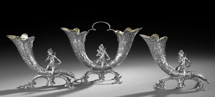 German Three-Piece .800 Silver Table Garniture: Unusual German Three-Piece .800 Silver Rococo Revival Table Garniture, first quarter 20th century, Hanau, comprising a pair of cornucopia vases, h. 8-1/2", l. 11-1/2", and a single addorsed cornucopia
