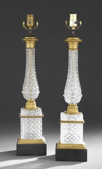 Pair of French Cut-Glass and Brass Table Lamps: Pair of French Empire-Style Cut-Glass and Brass Table Lamps, square black tole bases support cut-glass plinths trimmed in brass leaf molding, supporting strawberry pattern cut-glass vase-shaped column