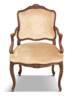 Provincial Louis XV-Style Fruitwood Fauteuil: Provincial Louis XV-Style Fruitwood Fauteuil late 19th century, the shaped and padded back surmounted by a floral crest, joined by molded and scrolling arms to the padded seat, raised on cabriole