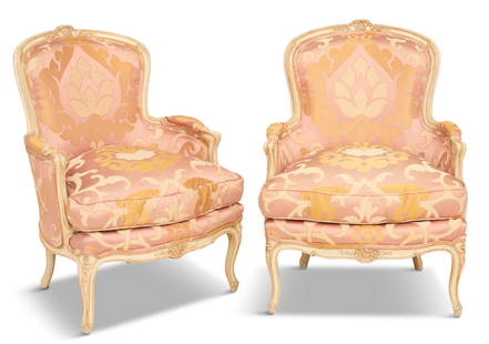 Pair of Louis XV-Style Creme-Peinte Bergeres: Pair of Louis XV-Style Creme-Peinte Bergeres 20th century, each with a carved and molded frame, the back centered with a floral cartouche, with reversible seat cushions and raised on cabriole legs.
