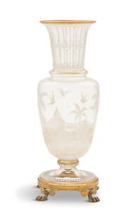 Gilt-Brass and Enameled Glass Vase: Gilt-Brass and Enameled Glass Vase fourth quarter 19th century, decorated with a white enamel orientalist landscape, the beaded base with gilt-brass trim and paw feet. h. 9-3/4", dia.