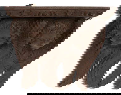 Italian Stained Oak Figural Bracket: Italian Stained Oak Figural Bracket 19th century, the shelf with a carved edge, supported by a backplate carved with winged angel's heads. h. 12", w. 13-3/4", d. 9-1/2" Provenance: