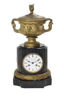 French Bronze and Marble Mantel Clock: French Bronze and Marble Mantel Clock fourth quarter 19th century, the base trimmed with a molded bronze laurel wreath, the clock with a column-form case set with a dial marked by the London