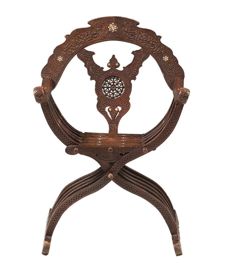 North African Hardwood Savonarola Chair: North African Hardwood Savonarola Chair 19th century, the domed back above a spindle wheel splat, joined by scrolled arms to the wooden seat, raised on an intersecting slatted base to runner feet, the