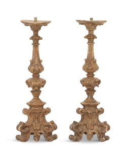 Pair of Continental Giltwood Altar Sticks: Pair of Continental Giltwood Altar Sticks19th century, in the Baroque taste, with leaf-carved capitals supporting the drip pans, the scroll-carved and fluted standards on carved tripartite bases, on s