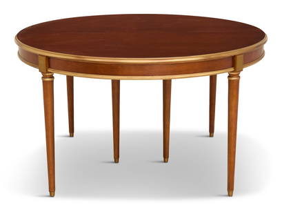 Louis XVI-Style Mahogany Dining Table: Louis XVI-Style Mahogany Dining Tableearly 20th century, the circular top with a gilt and molded edge, bisected and opening to accommodate a central leaf, raised above a plain frieze on tapered circul