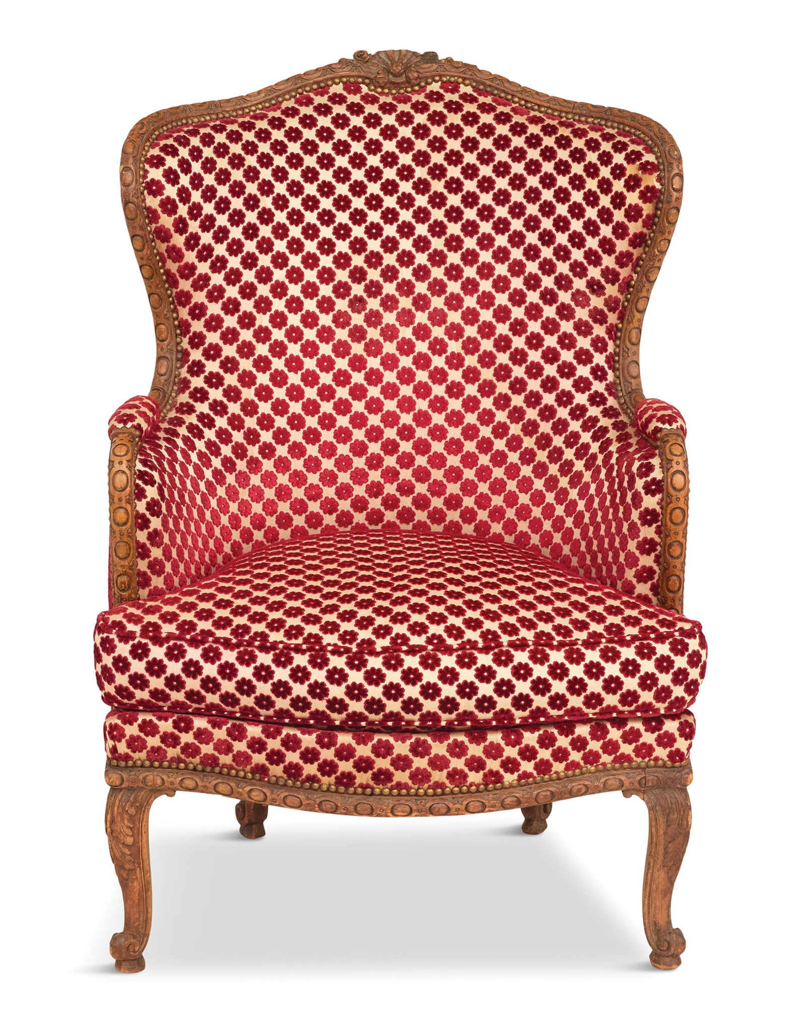 French Carved Fruitwood Bergere: French Carved Fruitwood Bergere19th century, the broad, curved back with a central floral and shell cartouche, with a reversible loose seat cushion, raised on short cabriole legs ending in scrolled to