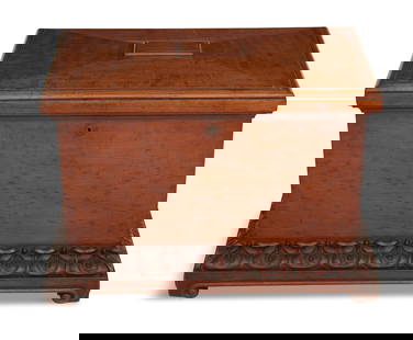 William IV Figured Mahogany Wine Cellarette: William IV Figured Mahogany Wine Cellarettesecond quarter 19th century, the hinged cover opening to reveal fittings for seven bottles, and the base carved with lotus leaves, over scroll-trimmed feet.h