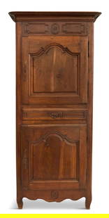 French Provincial Mahogany Bonnetiere: French Provincial Mahogany Bonnetiere19th century, the rounded and molded cornice above a conforming case fitted with a paneled frame over two paneled cupboards, divided by a drawer, raised above a sh