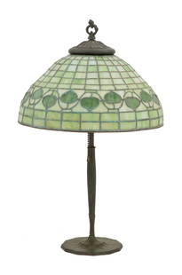 Tiffany Studios Leaded Glass Table Lamp: Tiffany Studios "Vine Border" Leaded Glass Table Lampca. 1905-1910, New York, the pierced finial over a stained and leaded glass shade decorated with a dark green vine on a light green ground, with a