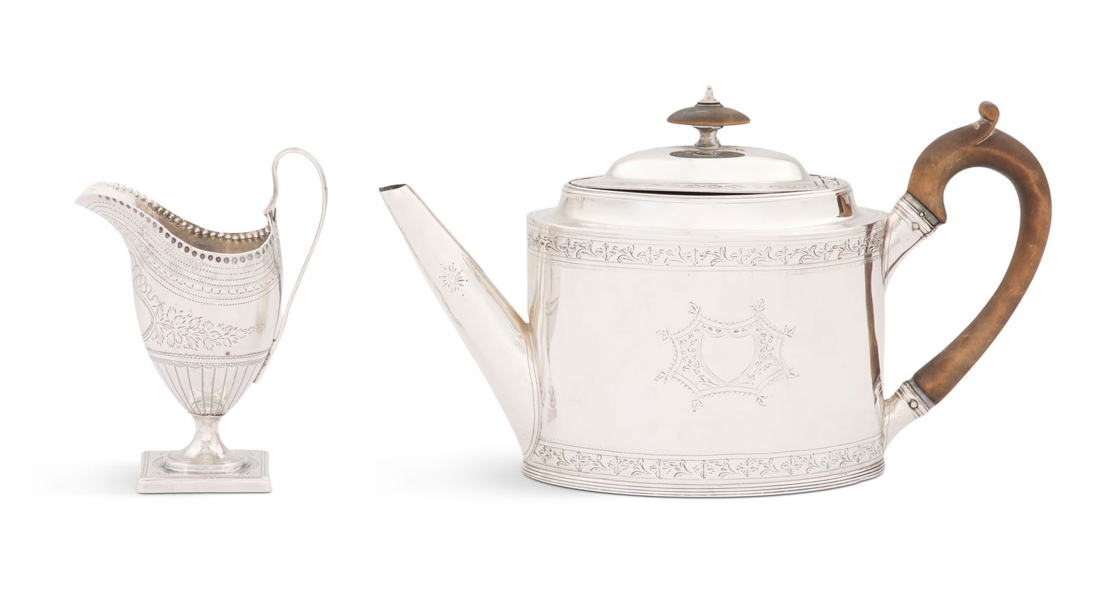 Late Georgian Sterling Teapot and Cream Jug: Late Georgian Sterling Silver Teapot and Cream Jugthe teapot hallmarked London, 1791-1792, by George Gray overstriking Peter & Ann Bateman, of navette section, with conical spout, crested wood handle