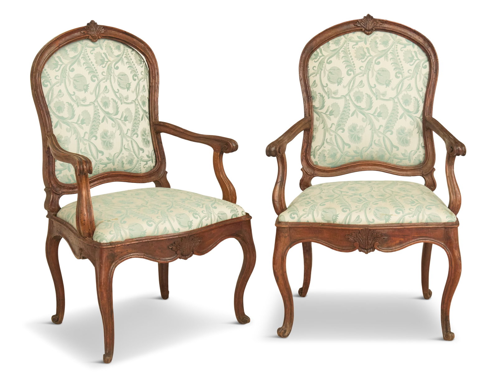 Pair of Italian Fruitwood Armchairs: Pair of Italian Fruitwood Armchairs mid-18th century, in the rococo taste, each with a molded and shaped back centered by foliate carving, serpentine seat rails and cabriole legs, with upholstered sli