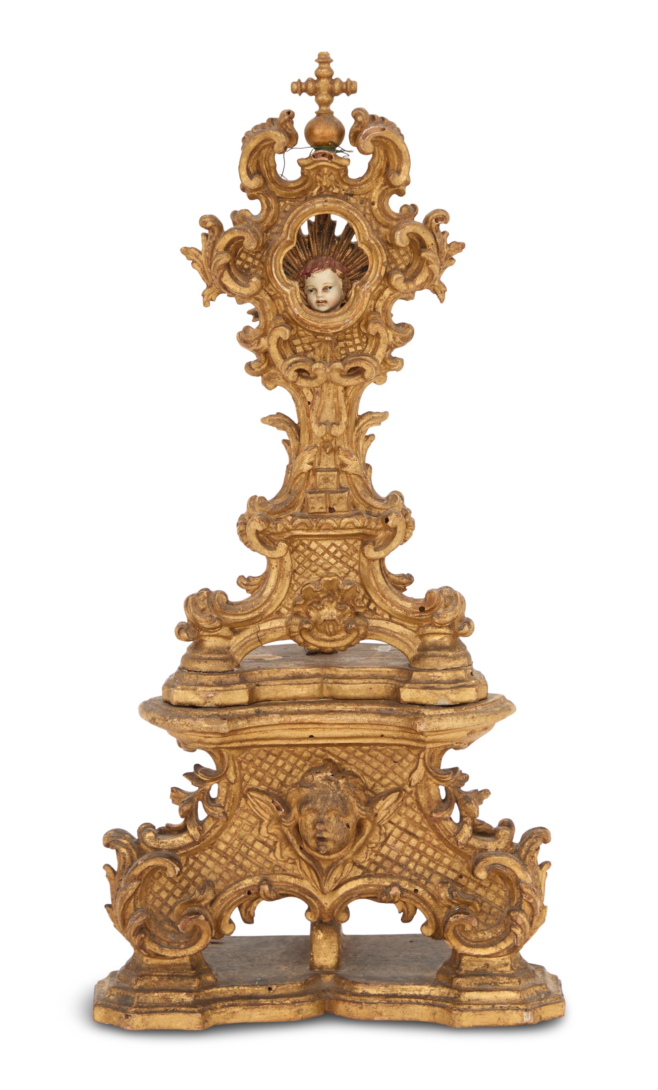 Handsome Italian Carved Giltwood Reliquary: Handsome Italian Carved Giltwood Reliquaryca. 1800, the aperture framed in carefully executed scrollwork, with a cross on top, now with a later head of Christ, the base decorated with a masque of a wi