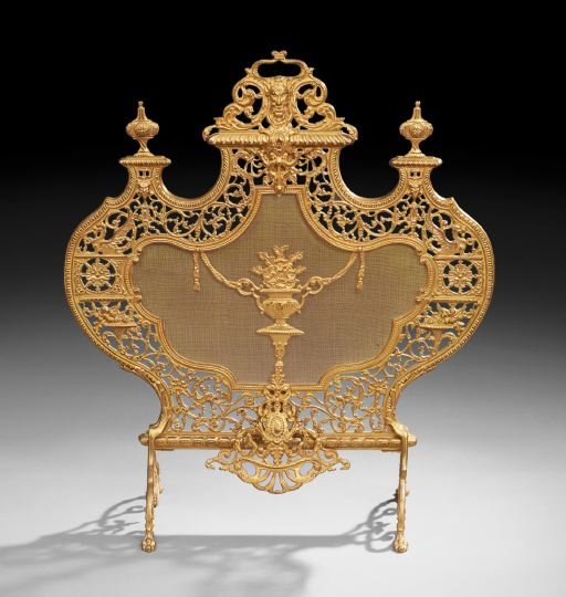 Beaux Arts Gilt-Metal Firescreen: Beaux Arts Gilt-Metal Firescreen, late 19th century, the shaped screen surmounted by a pierced masque cornice and surrounded by a scrolling foliate pierced frame, with a central floral basket, raised 