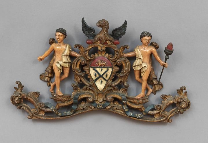 English Painted and Parcel-Gilt Armorial Board: English Carved, Painted and Parcel-Gilt Heraldic Crest Board, for the Worshipful Company of Glaziers and Painters of Glass, third quarter 18th century and later, the pierced, scrolled base carved with