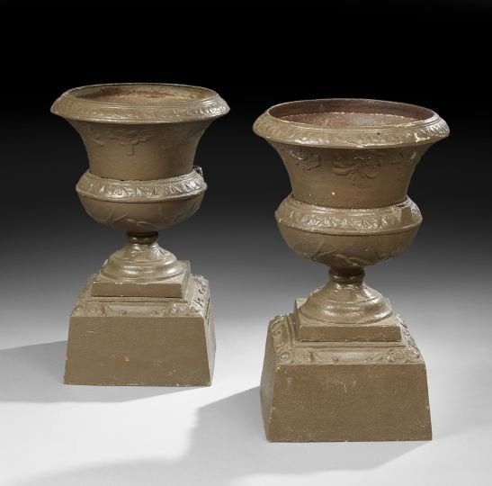 Pair of Cast-Iron "Bluebird" Pattern Garden Urns: Pair of American Cast-Iron Garden Urns in the "Bluebird" Pattern, with the molded label "Bloom Brothers Co Tiffin Ohio", each of campana form, the rims modeled with fleurs-de-lis, the lower bowl depic