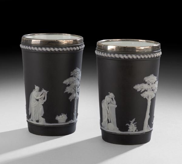 Pair of Wedgwood Black Beakers with Sterling Rims: Pair of Wedgwood Black Jasperware Beakers with Sterling Rims, ca. 1880-1881, decorated with classical sprigging alternating with trees, the rim marked by Brockwell & Son, London, h. 5-1/2", dia. 3-1/2