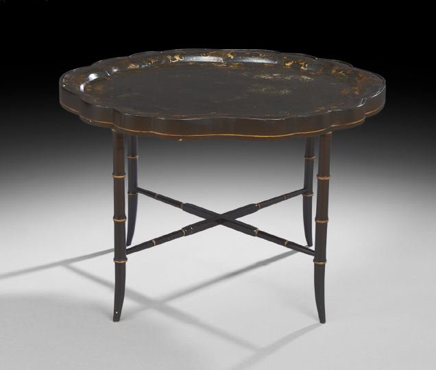 Regency Ebonized Papier-Mache Tray: Regency Ebonized Papier-Mache Tray, second quarter 19th century, the scalloped tray with a raised edge and elaborate gilt scrolling foliate banding, now raised on a later ebonized faux-bamboo stand wi