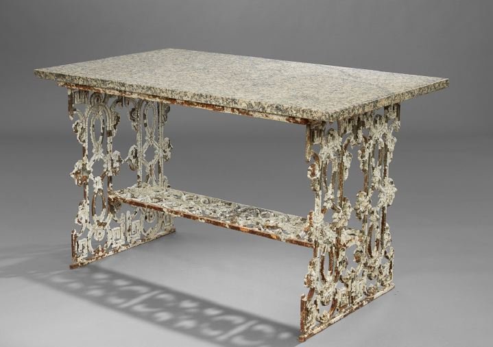 Antique Cast Iron and Granite Conservatory Table: Antique Cast Iron and Granite-Top Conservatory Table, the 19th-century trestle-form base presented in layers of old paint and featuring a later thick granite top, h. 32-1/4", w. 55", d. 32".