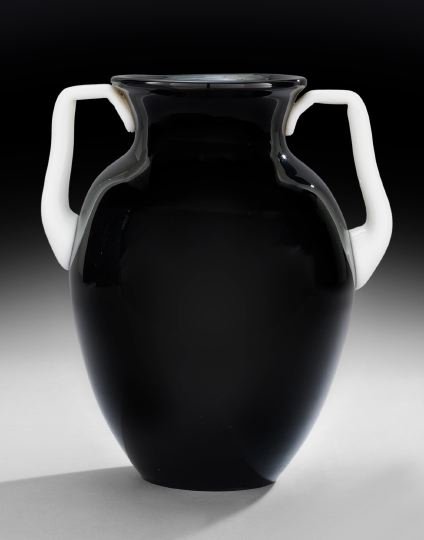 Black Glass Urn with Ivrene Handles: Black Glass Urn with Ivrene Handles, Attributed to Steuben, second quarter 20th century, New York, the unmarked urn with a black body with white handles and a polished pontil mark, h. 12", w. 10-3/4",