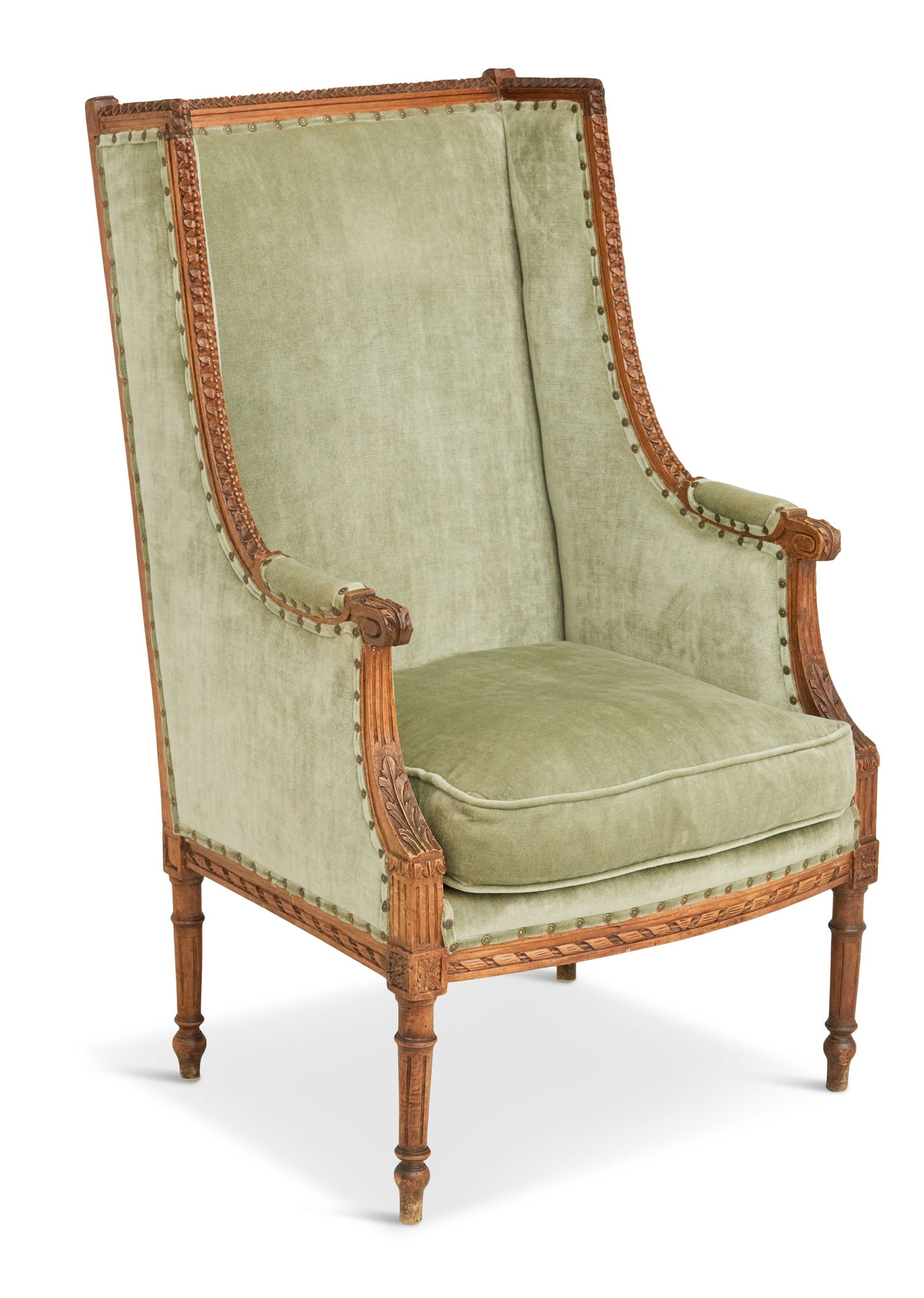 Louis XVI-Style Carved Walnut Wing Chair: Louis XVI-Style Carved Walnut Wing Chairearly 20th century, the carved frame with acanthine hand grips, reversible seat cushion and raised on turned, tapered and fluted legs.h. 44", seat. h. 17", w. 2