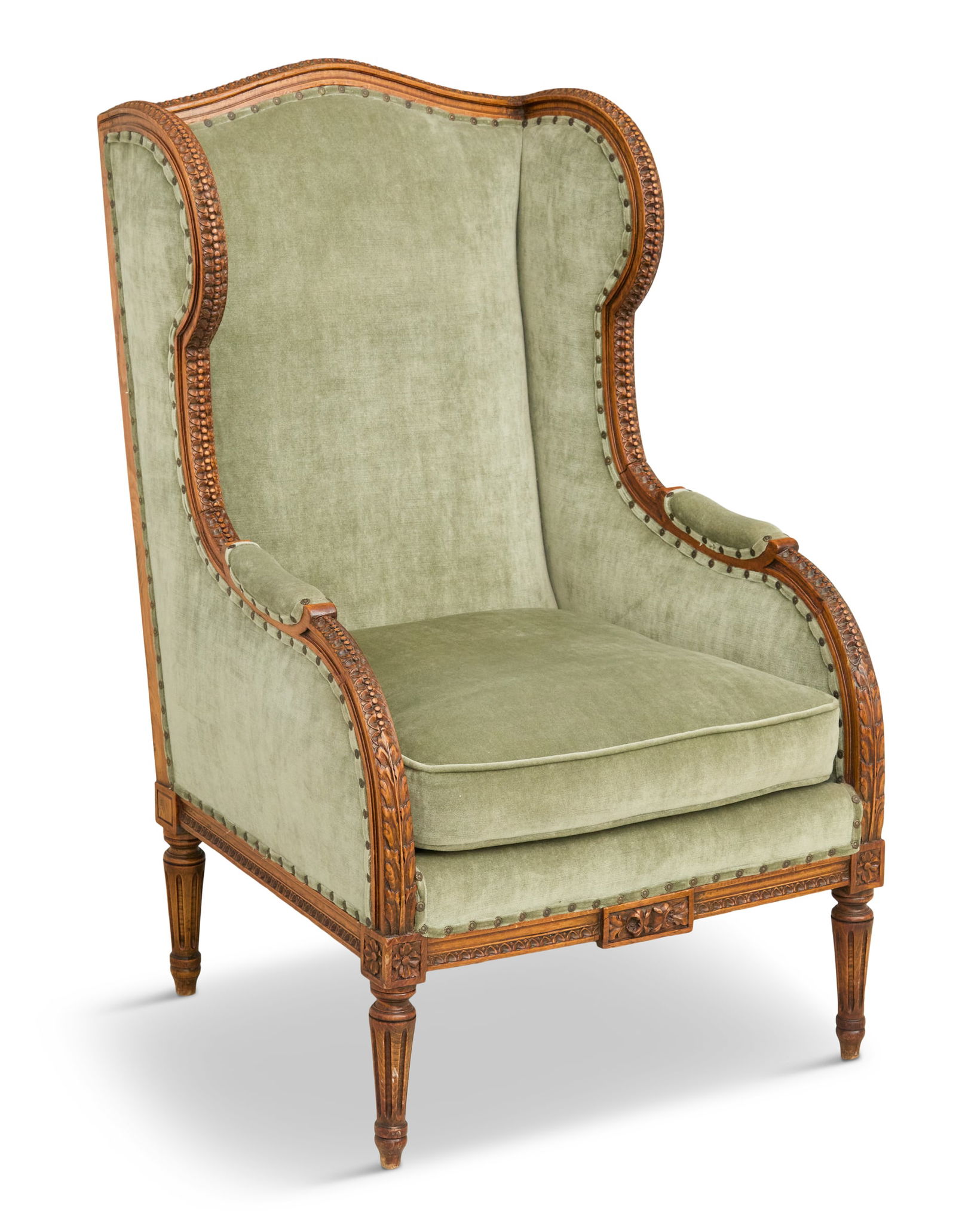 French Carved Fruitwood Wing Chair: French Carved Fruitwood Wing Chairearly 20th century, in the Louis XVI taste, with a reversible seat cushion and raised on tapered, turned and fluted legs.h. 45-1/2", seat h. 18-1/2", w. 27", d. 28"
