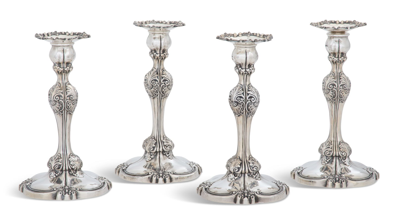 Four Tiffany-Retailed Silver Candlesticks: Four Tiffany-Retailed Rococo-Style Sterling Silver Candlesticksmid-20th century, each of baluster form above an integral base, quarter-lobed and decorated with shell-and-acanthus and anthemion motifs,