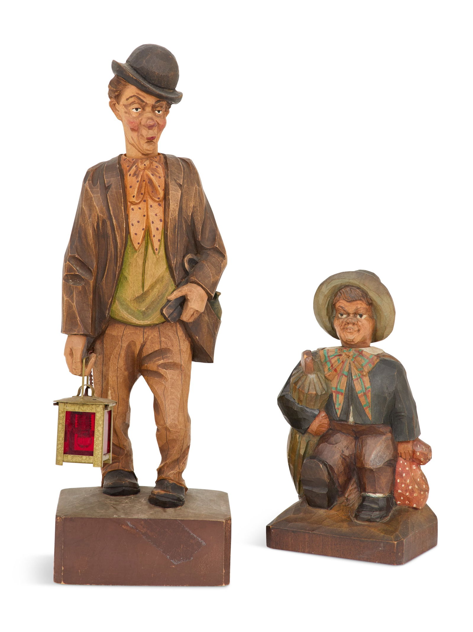 Two Black Forest Carved and Painted Automatons: Two Black Forest Carved and Painted Automatonsca. 1925-1940, attributed to Karl Griesbaum, the larger whistling figure of a drunkard with a flask in his pouch and a lantern in his hand, h. 15", w. 5",