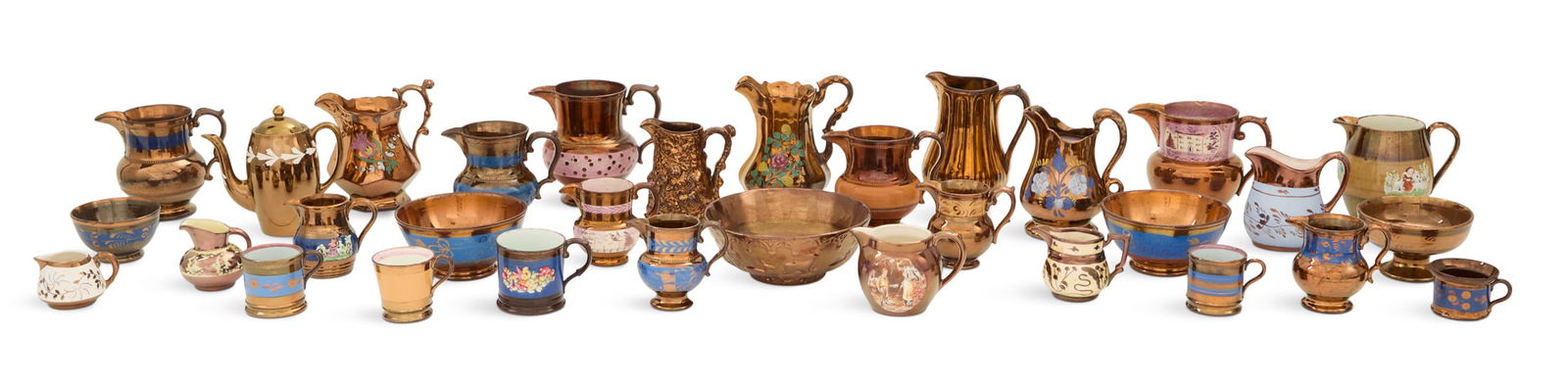 Collection of Copper Lustre Decorated Pottery: Collection of Copper Lustre Decorated Potteryearly 19th/early 20th century, the collection including:twenty-one pitchers, h. 2-1/4" to 7-1/4", w. 3-1/4" to 7-1/4";five bowls, dia. 4-1/4" to 8";five mu