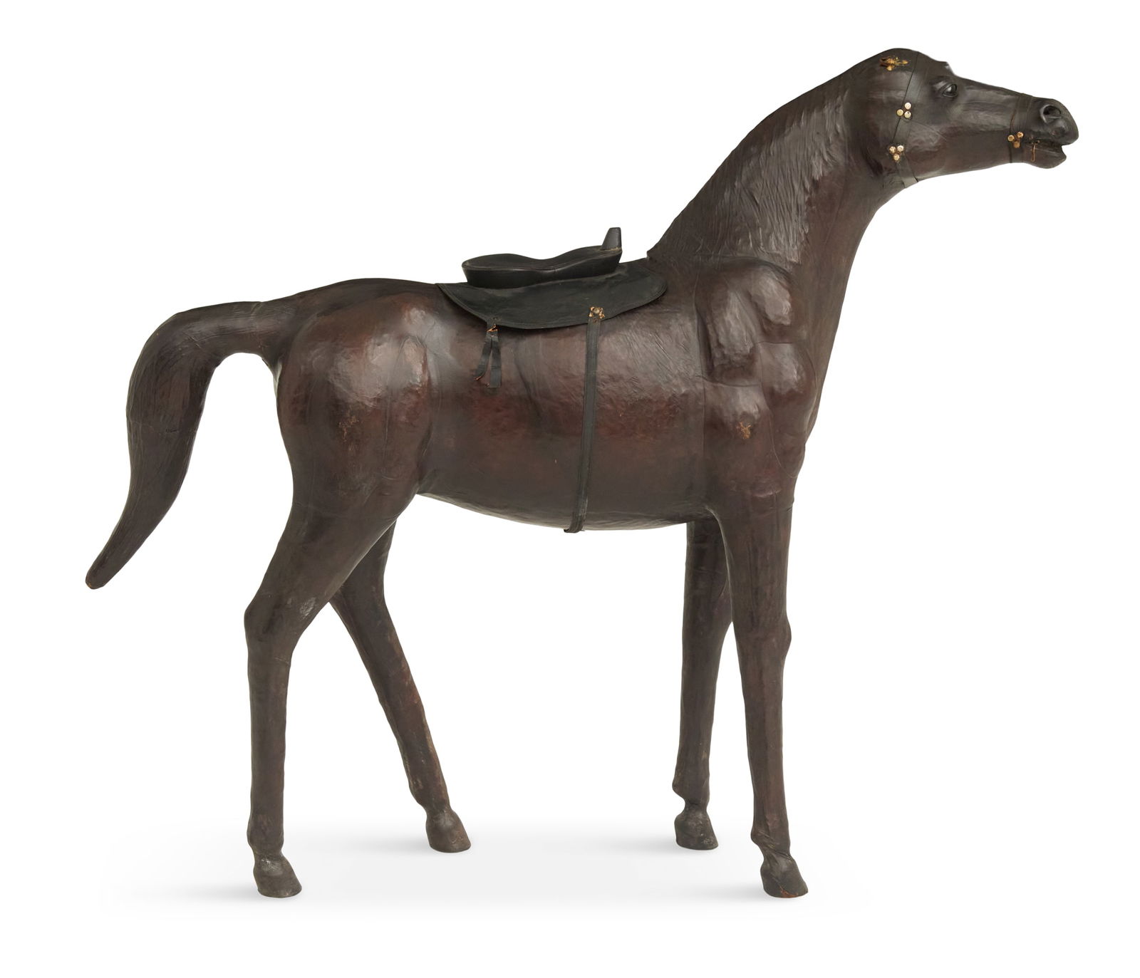 Large English Leather-Covered Model of a Horse: Large English Leather-Covered Model of a Horsemid-20th century, with an embossed mane, the brown horse with a black leather saddle, the bridle with brass studs.h. 47-1/2", w. 59-3/4", d. 14-1/2"